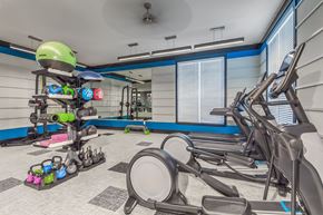 Raleigh apartment for rent - A gym with a row of treadmills and exercise equipment at Crabtree Lakeside Apartments, Raleigh