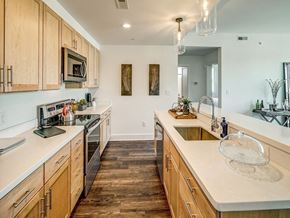 Charlottesville apartment for rent - a large kitchen with wooden cabinets and a sink