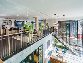 Charlottesville apartment for rent - the lobby of a building with a staircase and tables and chairs
