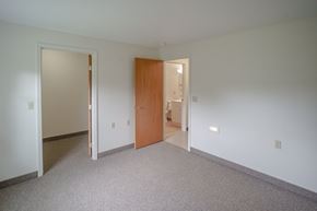 Colebrook apartment for rent - a bedroom with carpet and a door to a bathroom