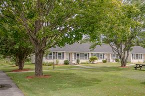 Colebrook apartment for rent - a large white house with trees in front of it