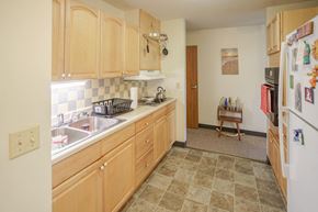 Whitefield apartment for rent - a kitchen with wooden cabinets and a sink and a refrigerator