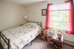 Whitefield apartment for rent - a bedroom with a bed and a table with plants