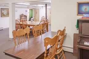 Whitefield apartment for rent - a dining room with a table and chairs and a piano