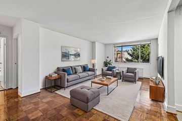 Washington apartment for rent - A living room with a grey couch and a painting on the wall.