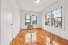 Washington apartment for rent - A room with wooden floors and white walls.