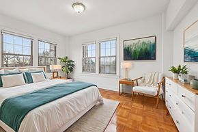 Washington apartment for rent - A bedroom with a large bed and a chair.