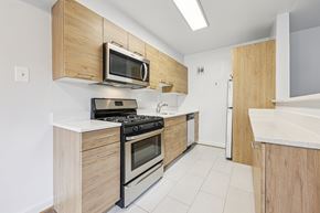 Washington apartment for rent - A kitchen with a stove top oven and microwave.