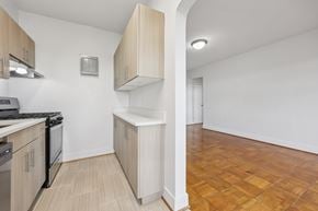 Washington apartment for rent - A kitchen with wooden cabinets and a tiled floor.