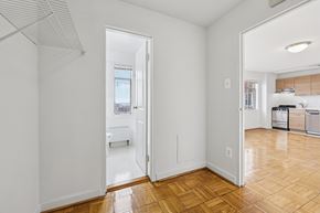 Washington apartment for rent - A kitchen with white cabinets and a wooden floor.