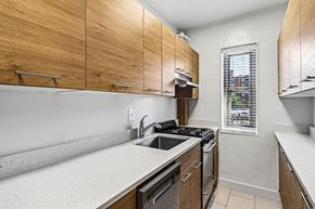 Washington apartment for rent - A kitchen with wooden cabinets and a window.