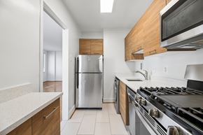Washington apartment for rent - A modern kitchen with a stainless steel refrigerator and oven.
