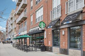 Washington apartment for rent - A Starbucks Coffee shop is located on a sidewalk in front of a brick building.