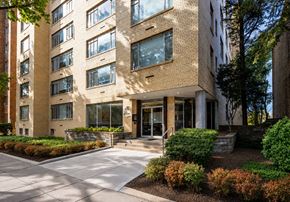 Washington apartment for rent - A modern building with a brick facade and a landscaped front yard.
