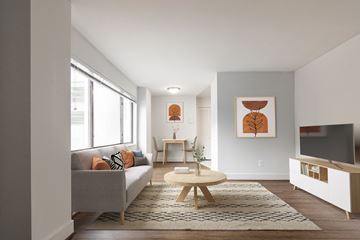 Washington apartment for rent - A living room with a grey couch, a wooden coffee table, and a painting on the wall.