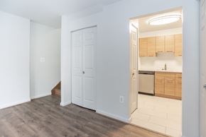 Washington apartment for rent - A kitchen with wooden cabinets and a white door.