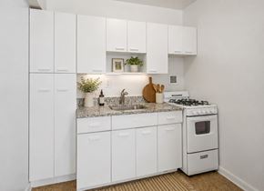 Washington apartment for rent - A white kitchen with a stove and sink.