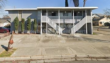 Stockton apartment for rent - a house with a porch and stairs on a street