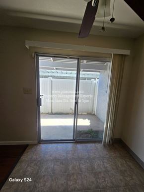 Modesto condo for rent - A room with a sliding glass door leading to a balcony.