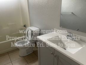 Stockton triplex for rent - a bathroom with a toilet and a sink