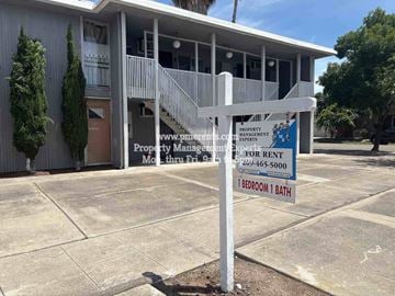 Stockton apartment for rent - A sign in front of a building advertises a property for rent.