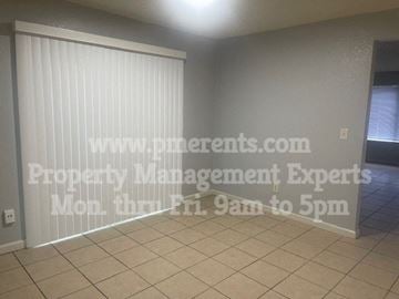 Stockton triplex for rent - A room with a sign that says "www.pme.com Property Management Experts Mon thru Fri. 9am to 5pm".