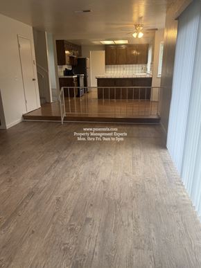Stockton apartment for rent - A spacious room with wooden flooring and a balcony with a railing.