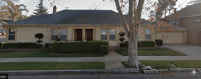 Stockton triplex for rent - A house with a brown door and a tree in front.