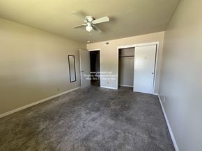 Stockton apartment for rent - A room with a ceiling fan and two doors.