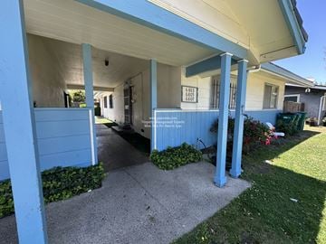 Stockton apartment for rent - A blue house with a sign that says "For Sale" on the front porch.