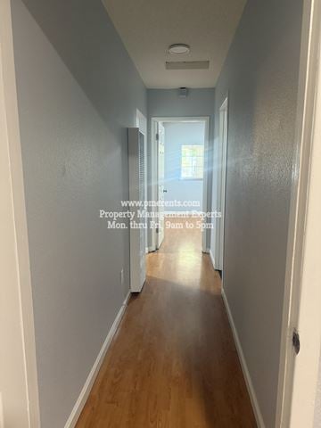 Stockton apartment for rent - A long hallway with a door at the end.