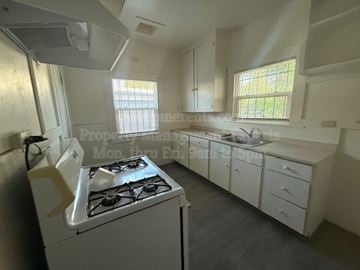 Stockton apartment for rent - A white kitchen with a stove and cabinets.