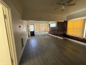 Stockton apartment for rent - A room with wooden flooring and a ceiling fan.