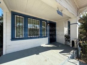 Stockton apartment for rent - A white house with blue trim and a sign that reads "E.S. CO.".