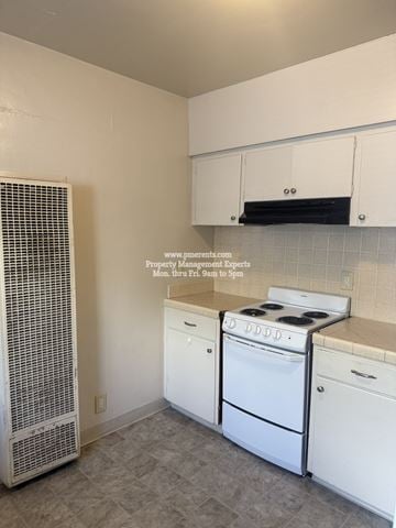 Stockton triplex for rent - A kitchen with white appliances and cabinets.