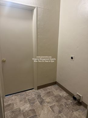 Stockton triplex for rent - A white door with a gold handle is in a room with a tiled floor.