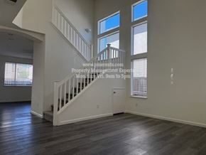 Stockton apartment for rent - A spacious room with a staircase leading to the upper level.