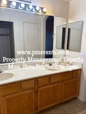 Stockton apartment for rent - a bathroom with a large mirror and a sink