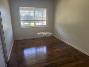 Stockton apartment for rent - A room with a window and wooden flooring.
