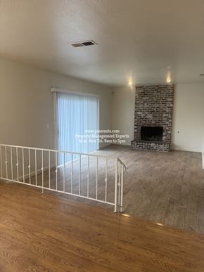 Stockton apartment for rent - A living room with a fireplace and a railing.