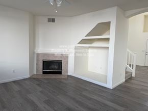 Stockton apartment for rent - A living room with a fireplace and a staircase.