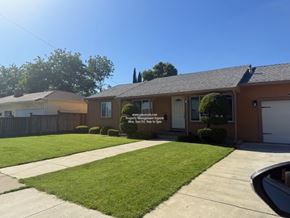 Stockton apartment for rent - A house with a brown roof and a white garage door.