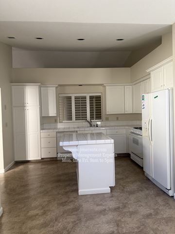 Stockton apartment for rent - A kitchen with white appliances and cabinets.