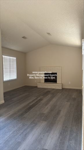 Modesto apartment for rent - A room with a wooden floor and a sign on the wall.