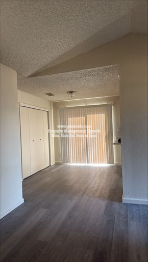 Modesto apartment for rent - A long hallway with a door at the end.