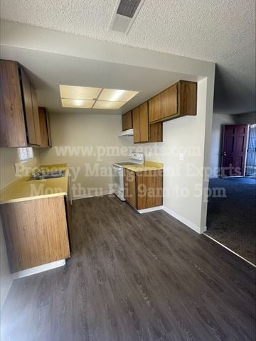 Stockton triplex for rent - A kitchen with wooden cabinets and a countertop is shown.