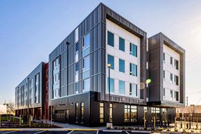 Vancouver apartment for rent - a modern building with a street in front of it
