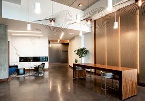 Vancouver apartment for rent - Lobby with large wooden table and seating for six. Polished concrete floor and marble fire place
