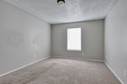 Pleasanton apartment for rent - an empty room with carpet and a window at Eagle View Apartments, Pleasanton, TX, 78064