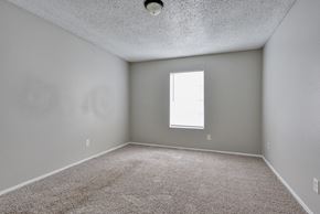 Pleasanton apartment for rent - an empty room with carpet and a window at Eagle View Apartments, Pleasanton, TX, 78064